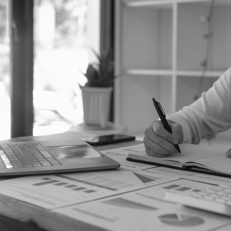 business woman taking note and using laptop for accounting financial