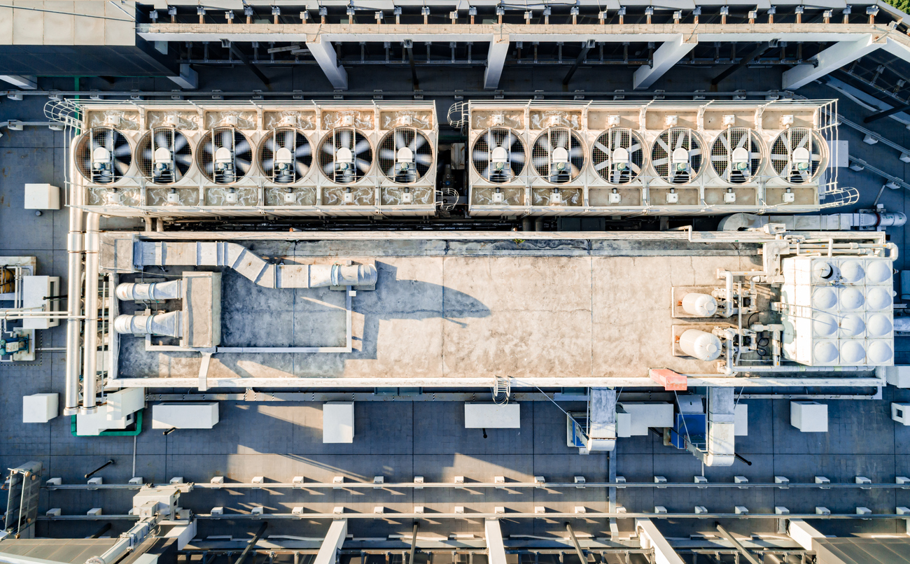 Aerial top down view of ventilation and air conditioning systems installed on the rooftop of a skyscraper in a developed business district