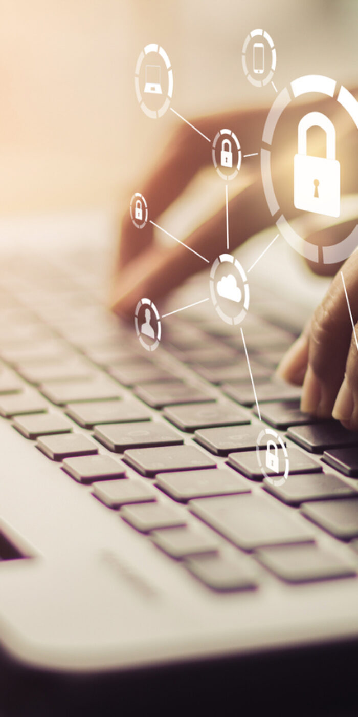 Business, technology, internet and networking concept. Young businesswoman working on his laptop in the office, select the icon security on the virtual display.