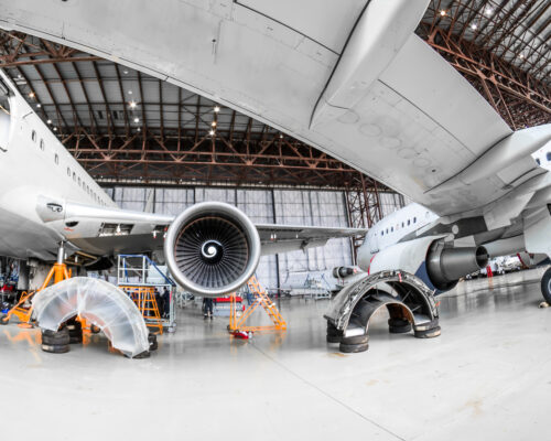 Aircraft in the hangar repair and maintenance, view from under the wing of the airplane