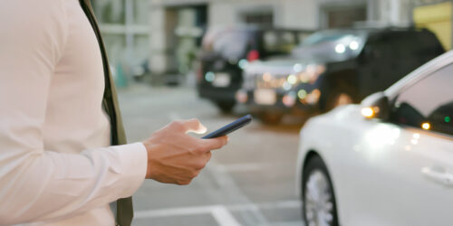 asian businessman unlock door of car by using smart phone