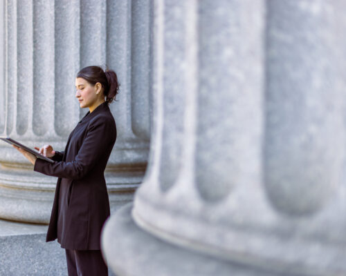 Hispanic latin female lawyer in front of the court house. Downtown Manhattan, New York, USA