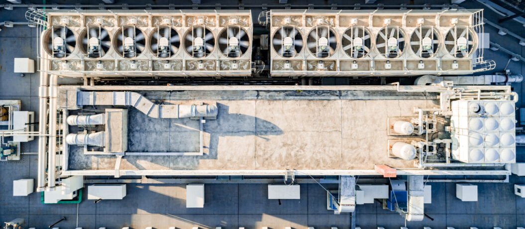 Aerial top down view of ventilation and air conditioning systems installed on the rooftop of a skyscraper in a developed business district