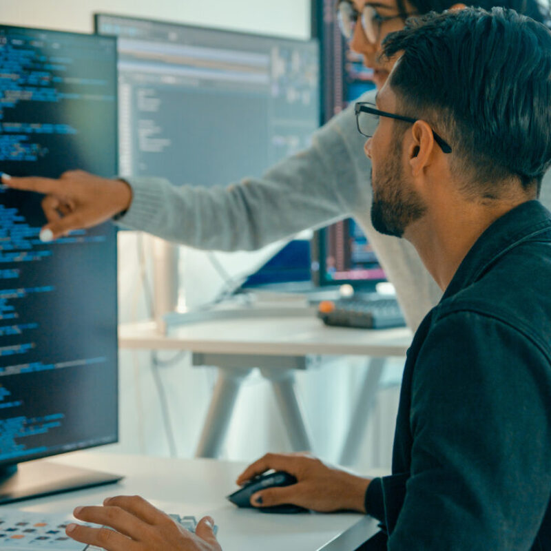 Tech team professionals collaborate discuss software development strategies in modern office. Software developer, artificial intelligence and programming concept.