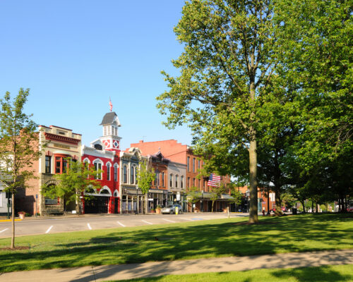 Medina, Ohio, USA - May 19, 2012: East Washington Street in Medina, Ohio, features a historic town hall and firehouse (bright red building) more than 130 years old.