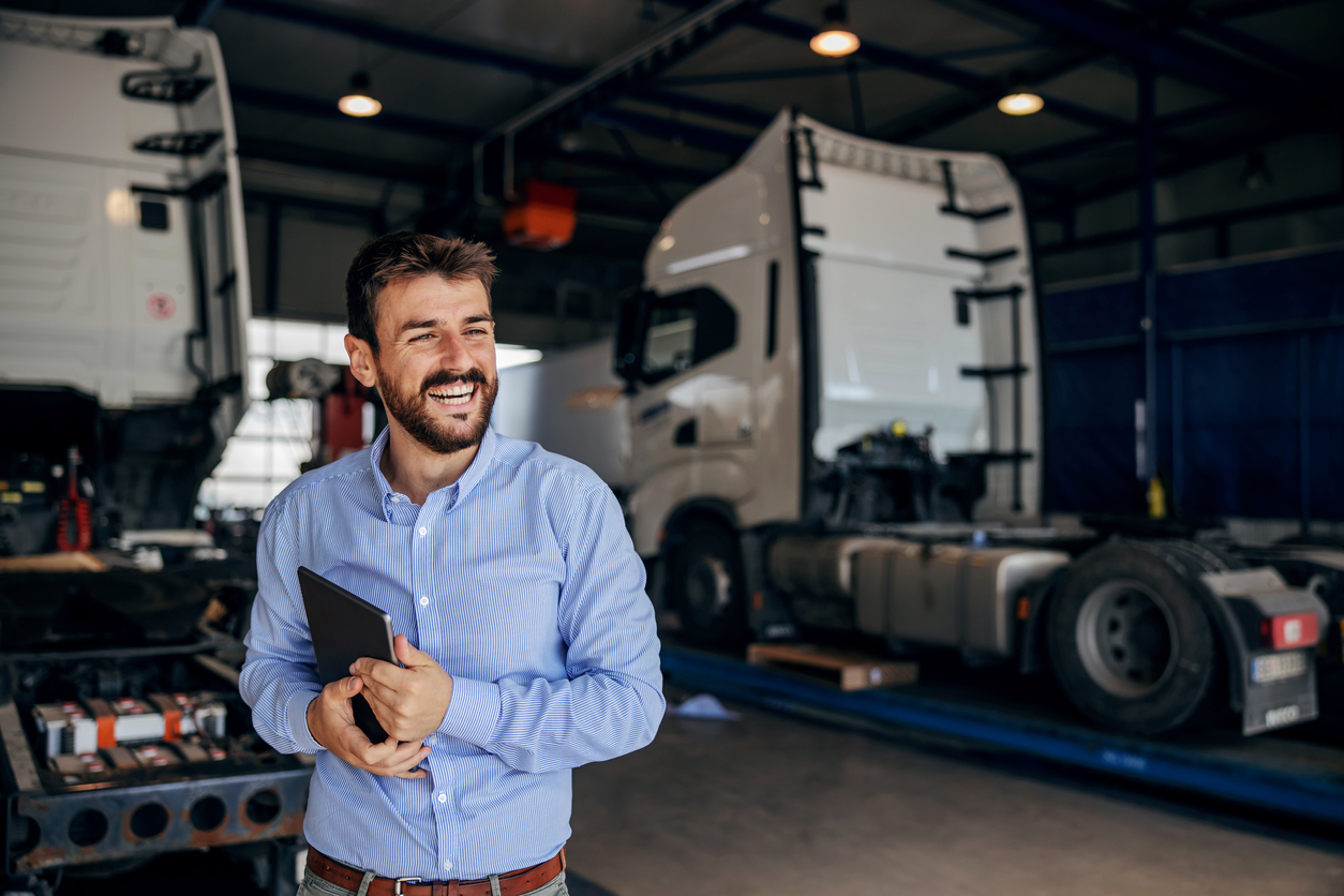 happy fleet worker by trucks