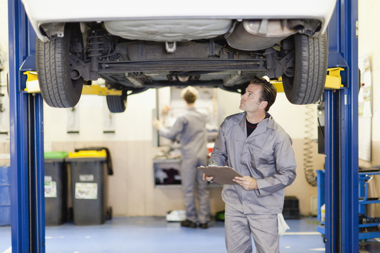 inspecting under vehicle in shop