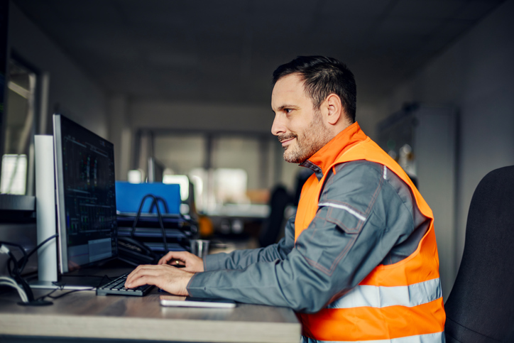 Industrial worker using computer for logistics management