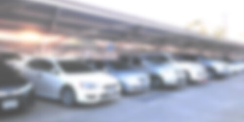Blur cars parked in the parking lot.