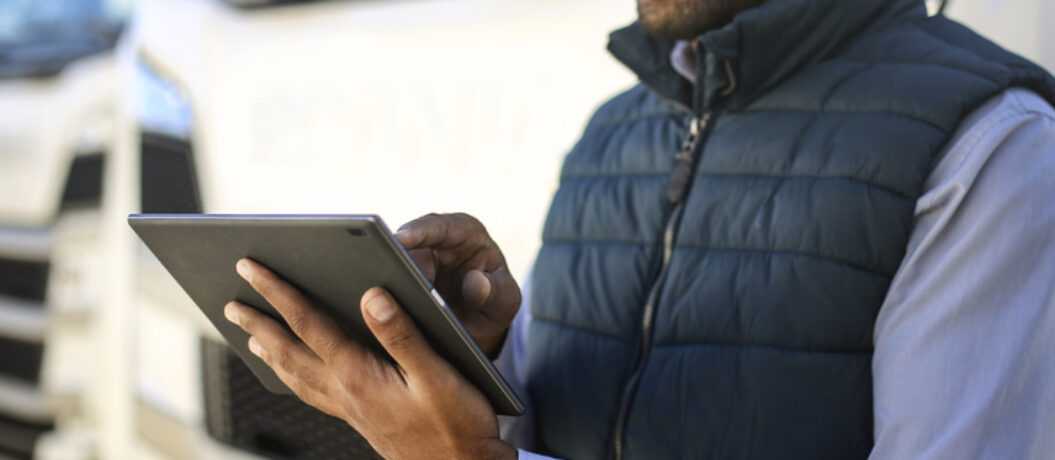 Truck driver using a tablet. About 35 years old, African male.
