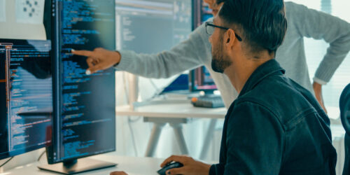 Tech team professionals collaborate discuss software development strategies in modern office. Software developer, artificial intelligence and programming concept.