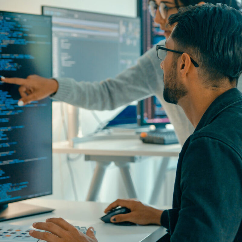 Tech team professionals collaborate discuss software development strategies in modern office. Software developer, artificial intelligence and programming concept.