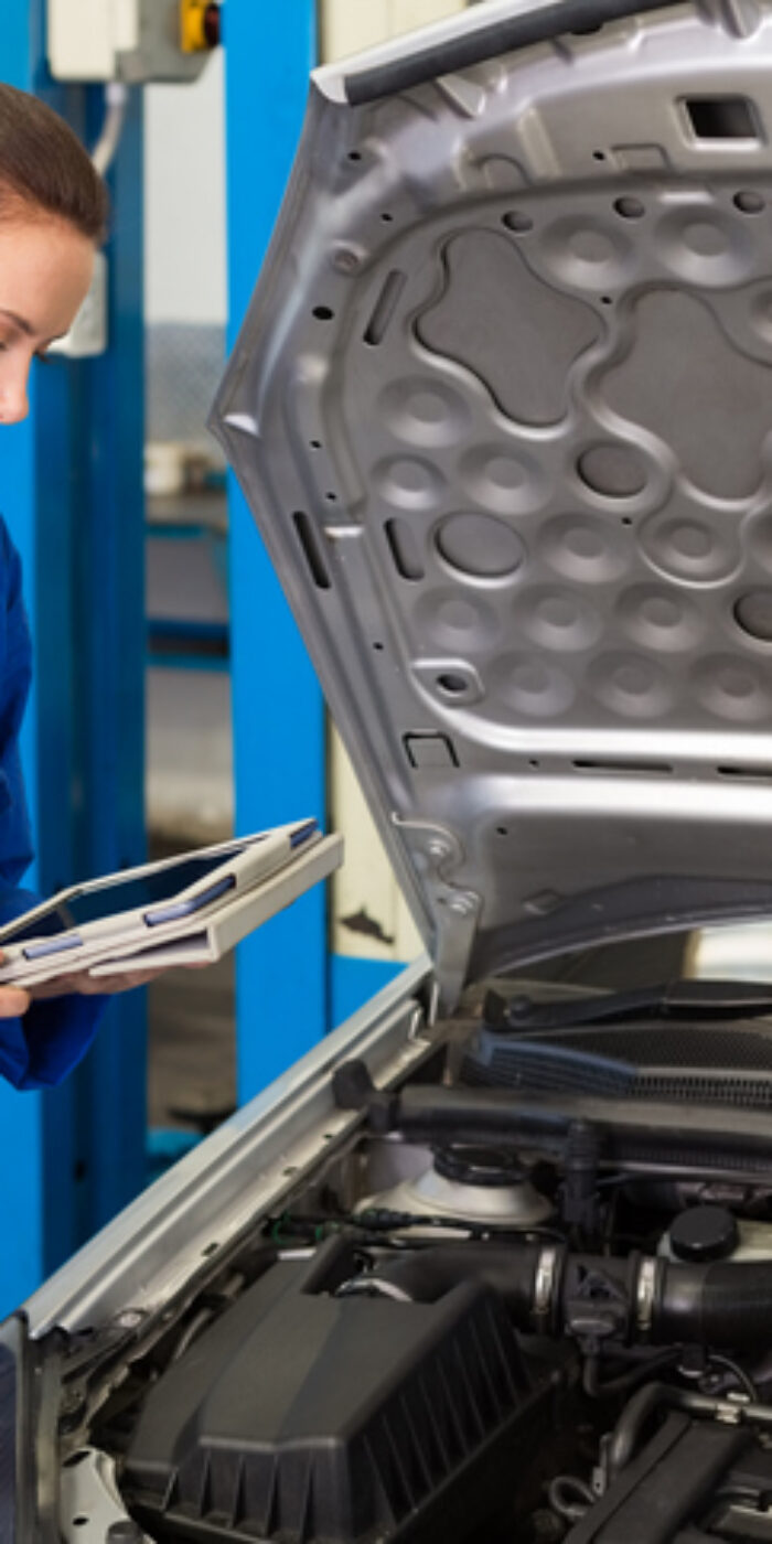 Mechanic using tablet to fix car at the repair garage