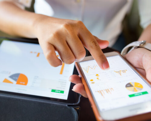 Businesswoman check data in smartphone and tablet