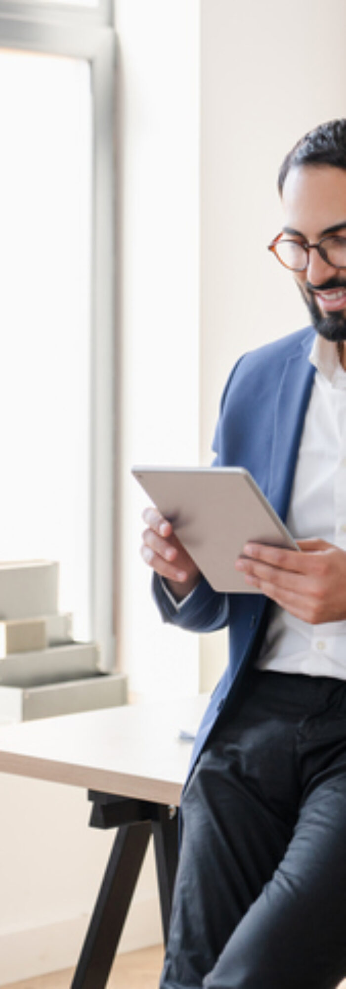 Confident successful arabian businessman tutor freelancer CEO working on digital tablet, watching webinars, e-learning, checking e-mails social media, reading news. Middle Eastern financial advisor